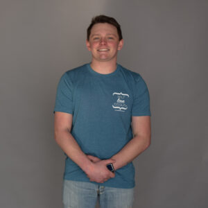 Teal shirt with white Self Love Beauty logo