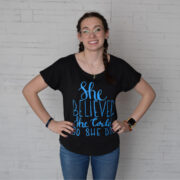 Short sleeved "she believed she could so she did" shirt in black with blue writing